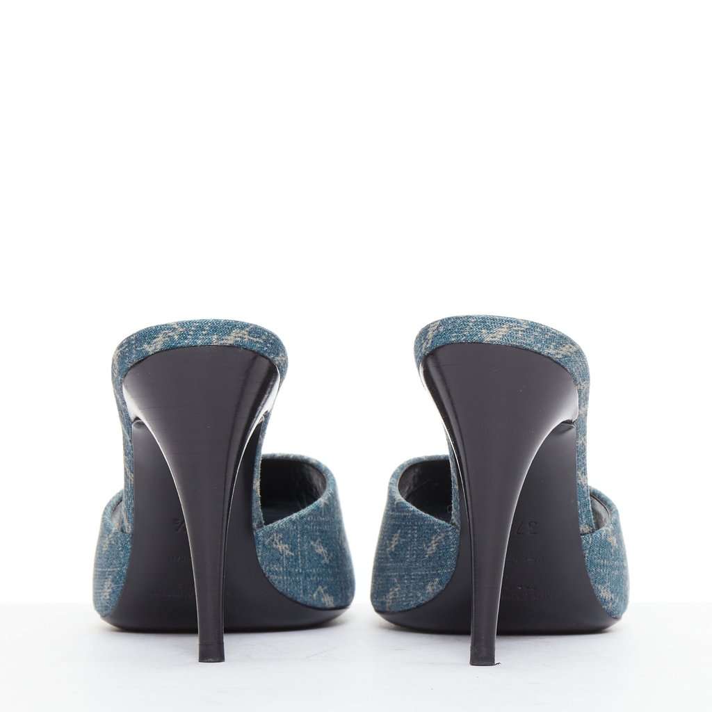 Saint Laurent Step into effortless Parisian chic with these YSL Cassandre mules, featuring all-over tonal YSL logo embroidery in washed denim and a sleek stiletto heel. Blue Denim Very good condition - Box View