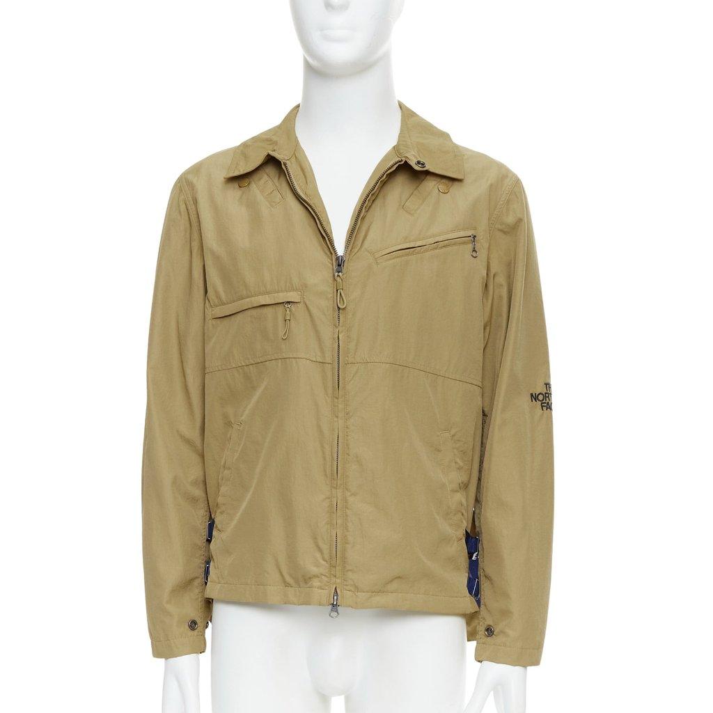 The North Face سترة واقية من الرياح بحواف زرقاء