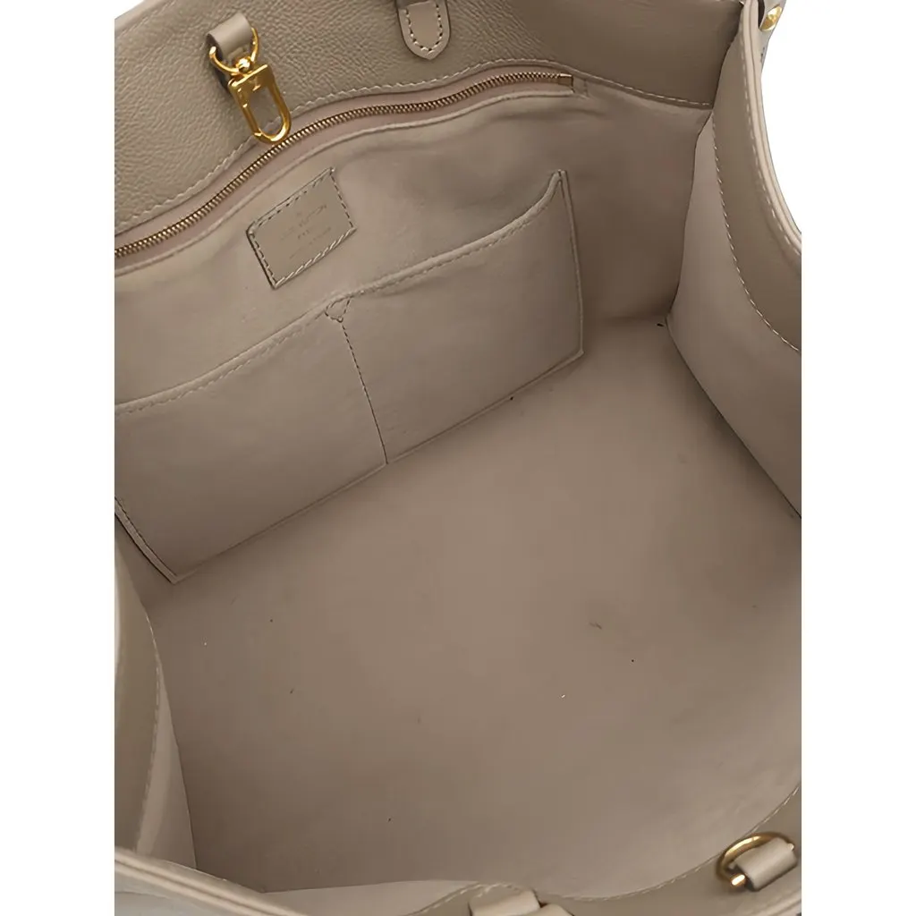 Louis Vuitton Monogram Empreinte OnTheGo MM Beige Leather Good - Model View