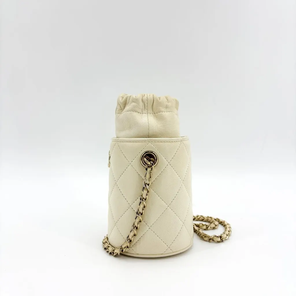 Chanel Lambskin Quilted Mini Drawstring Bucket Bag Ivory Gold Hardware Gold Leather Good - Model View