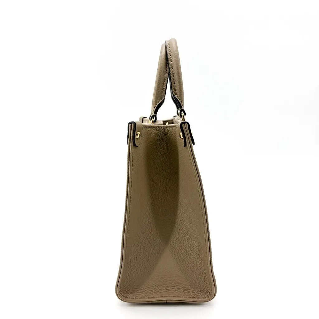 Louis Vuitton On the Go PM Monogram Empreinte Tourtrell Crème Beige Leather Good - Model View