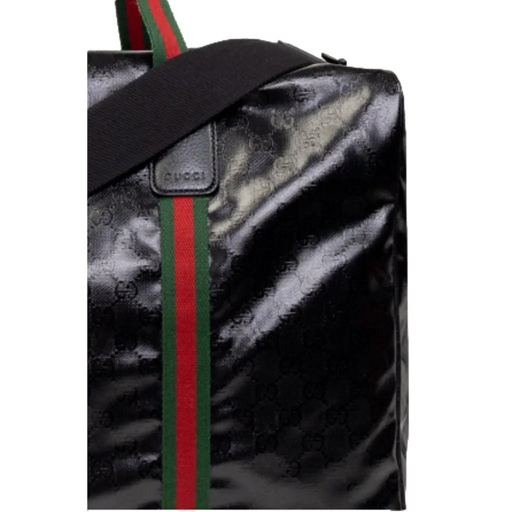 Gucci Duffle Maxi GG Black Glossy Fabric Duffel Bag Leather Trim Black Leather Never worn - Model View